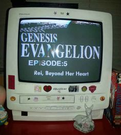 an old television sitting on top of a red table