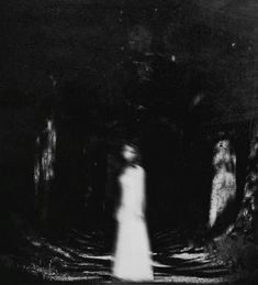 a ghostly woman walking through a dark forest