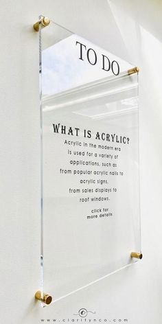 an acrylic sign hanging on the side of a wall