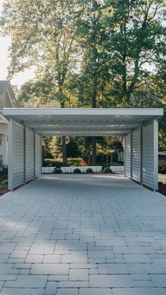 an outdoor covered parking lot with trees in the background