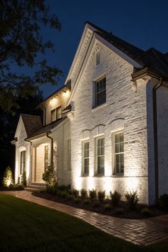a white house lit up at night with lights on