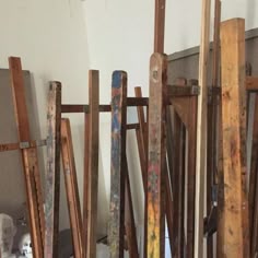 several pieces of wood are stacked on top of each other in an unfinished room with white walls