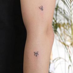 a woman with a tattoo on her arm and the word love written in cursive writing