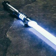 a light saber laying on top of a stone floor