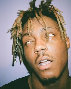 a young man with dreadlocks on his head