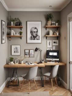 a home office with two desks and pictures on the wall above it, along with shelves filled with books
