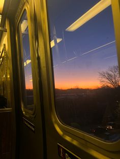 the sun is setting in the distance as seen from inside a train car with its doors open