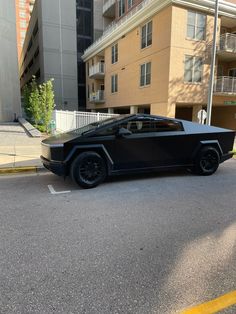 a black car is parked on the street