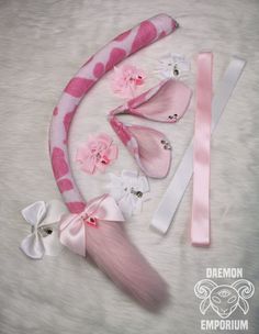 pink and white hair accessories laid out on a fur surface