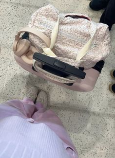 someone is sitting on the floor with their luggage