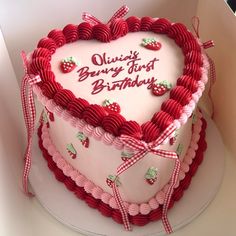 a heart - shaped cake with the words quiesy berry first birthday written on it