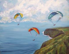 three parasailers are flying over the ocean on a sunny day with white clouds