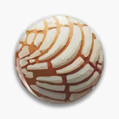 a brown and white pattern on a button or pinback, that is made out of glass