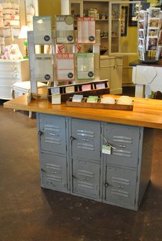 a large metal locker sitting in the middle of a room next to a wooden counter