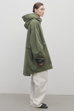 Khaki Techwear Winter Raincoat, Oversized Green Utility Outerwear, Oversized Green Outerwear With Drawstring Hood, Oversized Green Winter Utility Jacket, Oversized Khaki Hooded Parka, Oversized Spring Parka, Green Cotton Utility Parka, Oversized Cotton Parka With Drawstring Hood, Oversized Green Parka