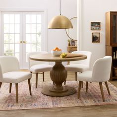 a dining room table with four chairs around it