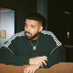 a man with a beard sitting at a table
