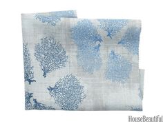 two pieces of blue and white fabric with corals on them, one is folded in half