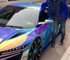 a man standing next to a colorful car