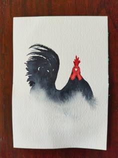 a piece of paper with a painting of a rooster on it