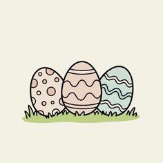 three eggs sitting in the grass with one egg painted on it's side,
