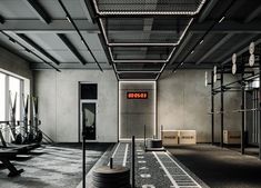 an empty gym with rows of exercise equipment
