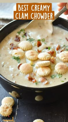 a bowl of clam chowder with dumplings in it and a spoon sticking out