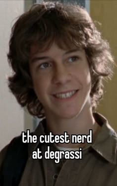 the cutest nerd at degrassi is smiling for the camera, and he has