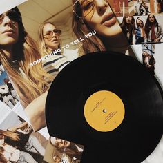 an old record is laying on top of some magazine pages with photos of women in the background