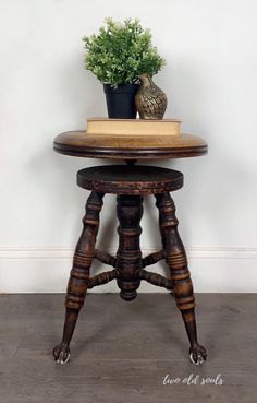 an old wooden table with a potted plant on top