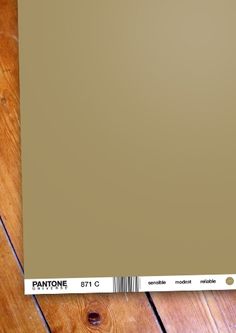 a pantone color swatch sitting on top of a wooden floor