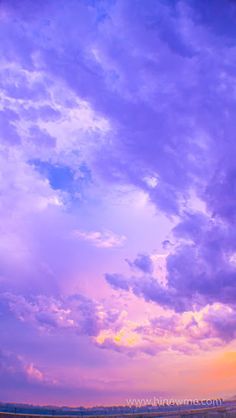 the sky is purple and blue with clouds