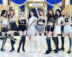 girls'generation members posing in front of a stage