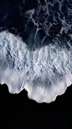 an aerial view of the ocean with waves
