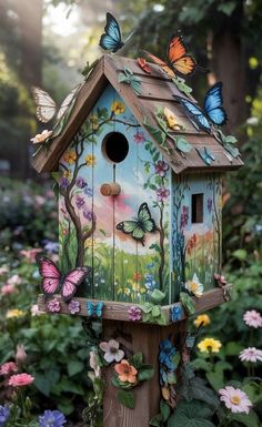 a bird house with butterflies painted on it