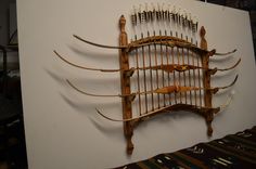 a wall mounted archery rack with arrows on it's sides and an arrow in the middle