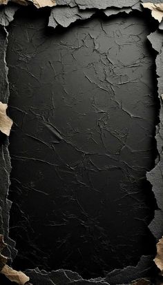 an old black background with some torn up paper in the middle and one corner missing