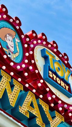 the sign for toy story way is painted red, yellow and blue with an image of woody on it