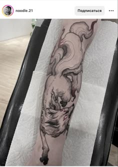 a person with a black and white tattoo on their leg