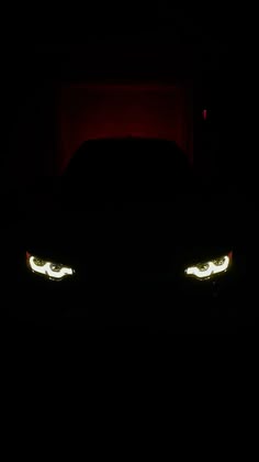the headlights of a car are glowing in the dark