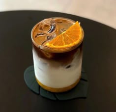 an orange slice is placed on top of a drink