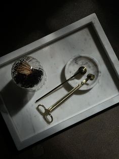 a pair of scissors sitting on top of a tray