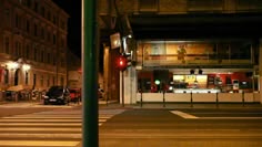 an empty street at night with traffic lights