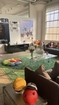a living room filled with lots of furniture and colorful pillows on top of the floor