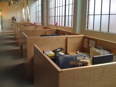a row of wooden desks in an office