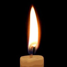 a lit candle on a black background