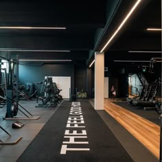 an empty gym with treadmills and exercise equipment on the floor in front of it