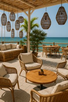 an outdoor seating area with wicker furniture overlooking the ocean