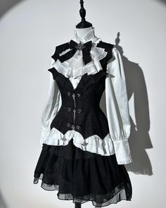 Unveil the Dark Beauty of Our White and Black Gothic Lolita Set 🖤✨ 💀 The full set includes a chic shirt, a tailored waistcoat, and a mysterious spider web fabric skirt. 🔍 Search “UNK-087” on devilinspired.com to get the full set for just $79.75! 🛒 Don’t wait, shop now! #GothicFashion #SpiderWebSkirt #GothicChic #DarkElegance #DevilInspired Outfits For Reference, Vest Clothes, Black Shirt Ideas, Dark Themed Outfits, Cute Witch Outfit, Black And White Items, Gothic Clothing Aesthetic, Formal Cute Outfits, Iconic Clothes