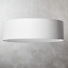 a white lamp hanging from a ceiling in a room